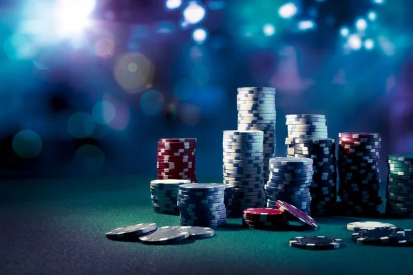 Live dealer rolling three dice in transparent container